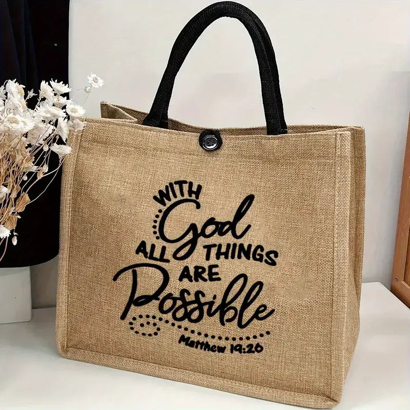 Natural jute tote bag with black cotton handles and button closure, featuring the verse "With God All Things Are Possible – Matthew 19:26" on the front. Measures 12.20" tall x 13.78" wide x 6.69" deep.