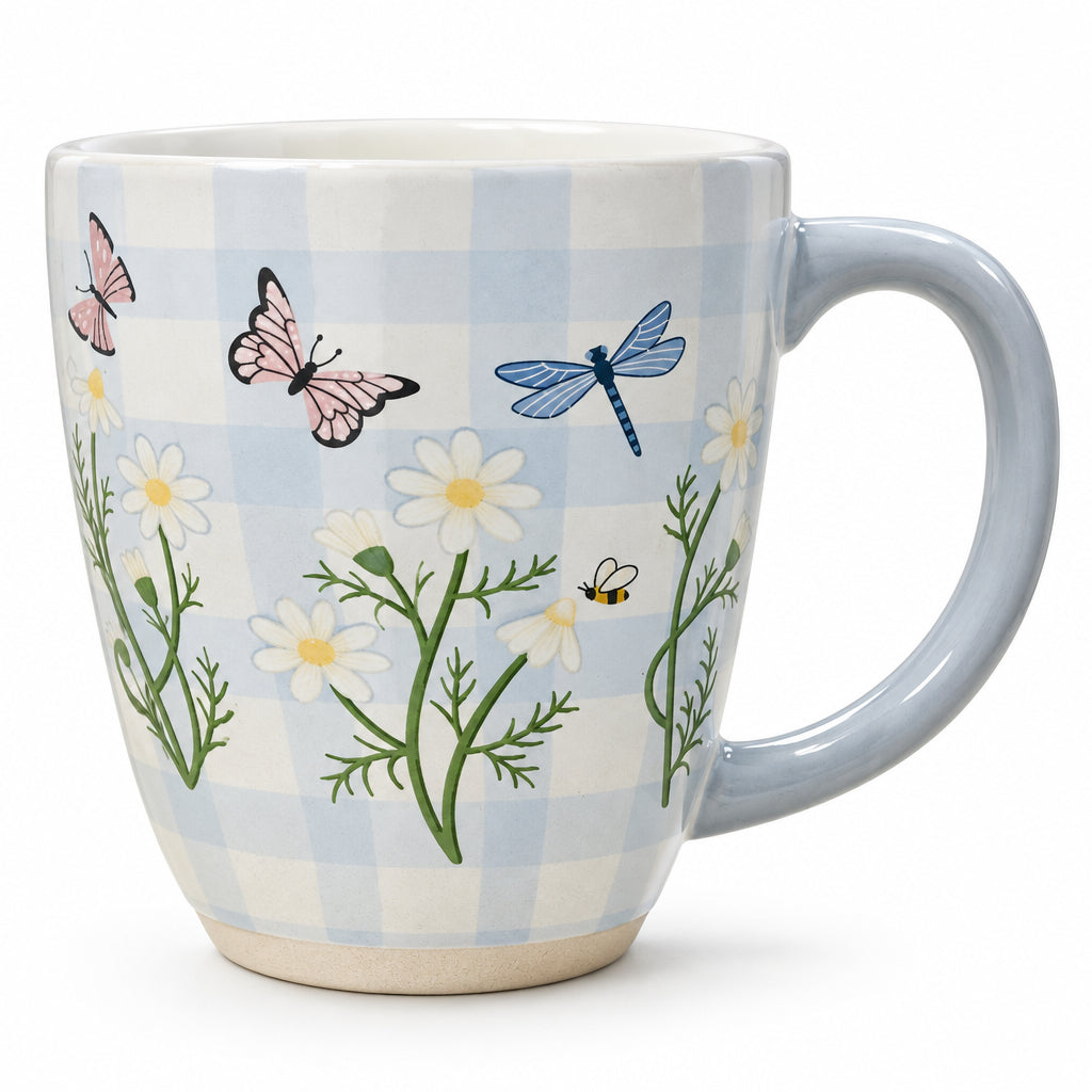 A ceramic mug with a light blue and white gingham pattern, decorated with illustrations of pink butterflies, a blue dragonfly, white daisies, and green leaves.