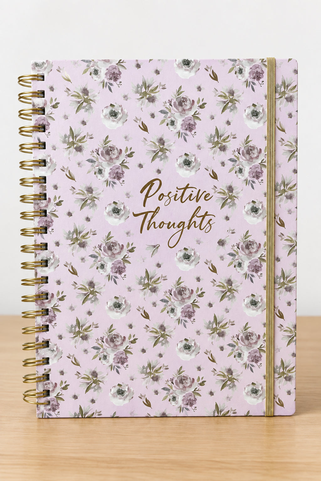 Purple notebook with mauve flowers and the words “Positive Thoughts” on the cover, measuring 8 1/2 by 11 inches.