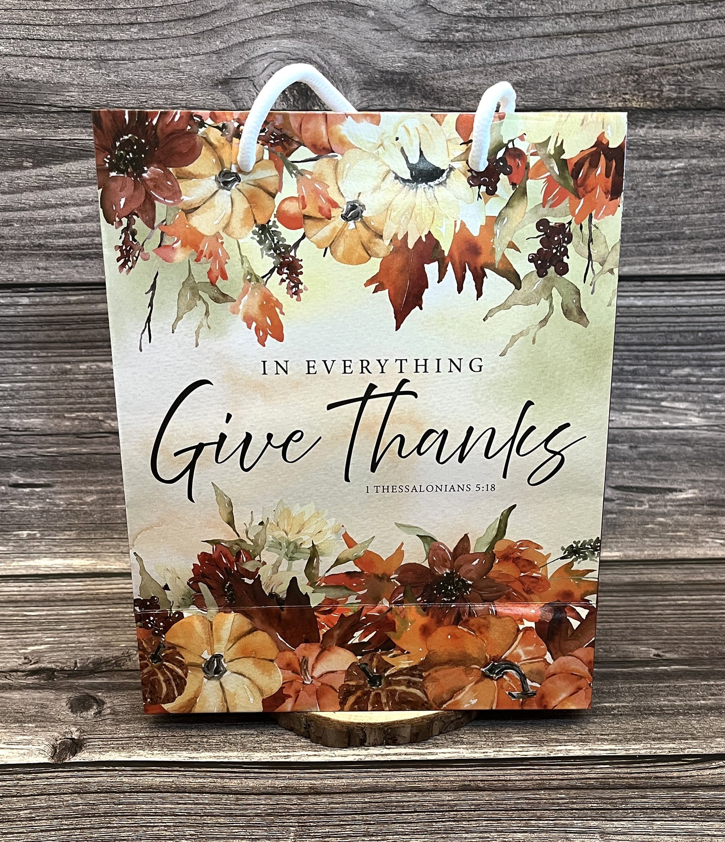 Christian fall paper gift bag with autumn floral design and the Bible verse “In everything give thanks” from 1 Thessalonians 5:18, size 8x10 inches
