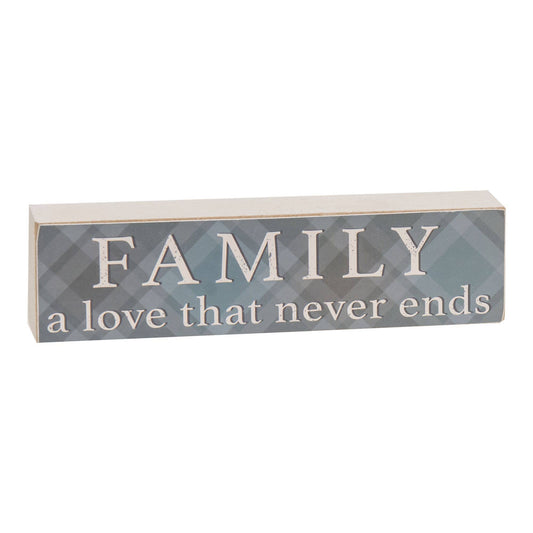 Wooden block sign with teal plaid background, distressed white edges, and the phrase “Family a love that never ends” in white lettering.