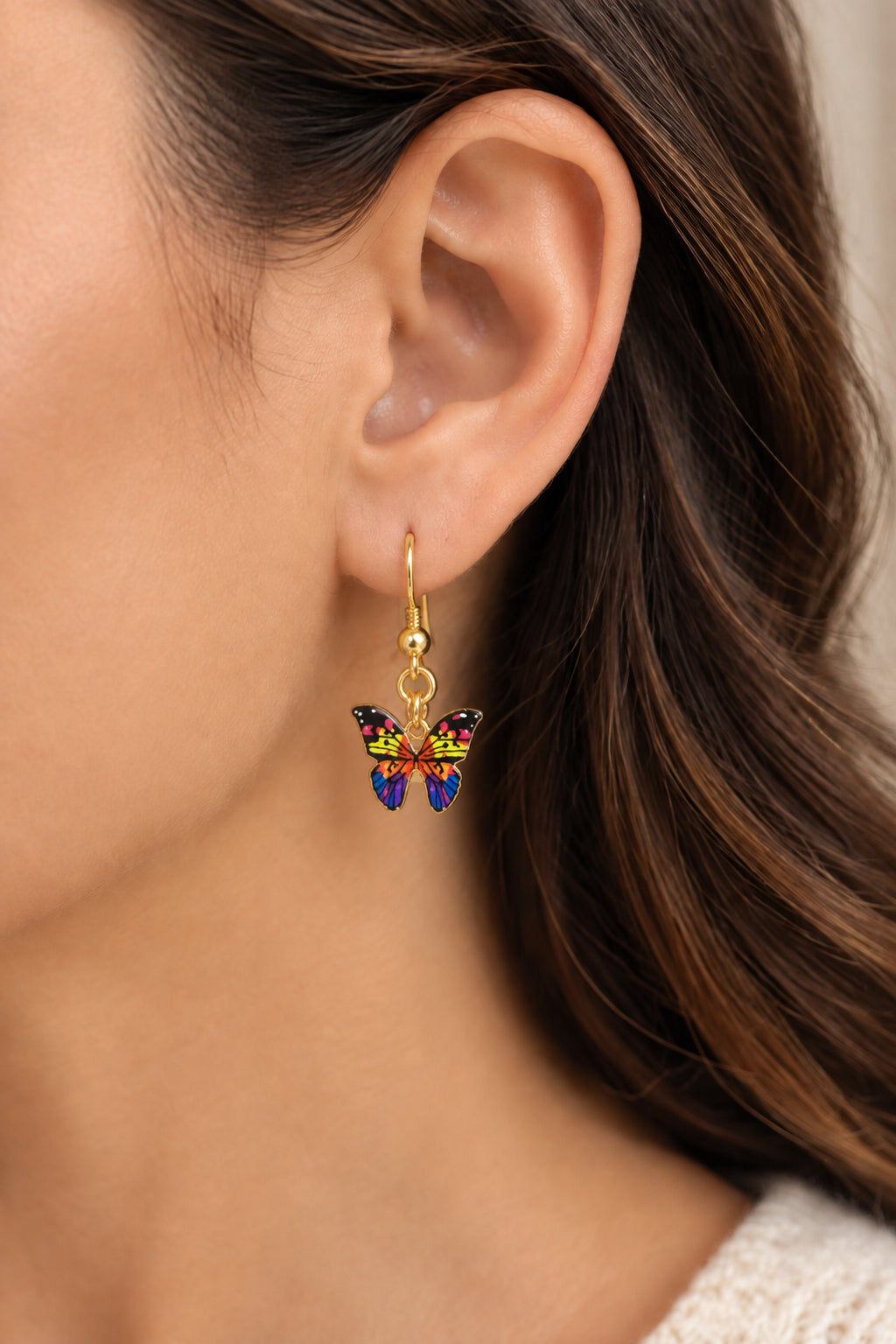 Multicolored butterfly earrings in yellow, blue, and purple, approximately 1 inch long, with gold-toned interchangeable lever back ear wires.