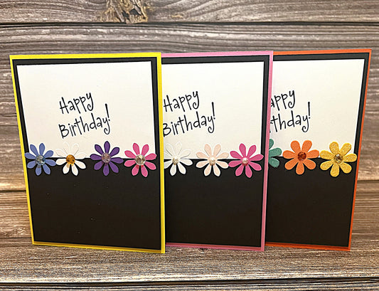 Set of 3 Happy Birthday cards, 4 1/4 x 5 1/2 inches, multicolored base with black accents, paper flowers, and glitter highlights