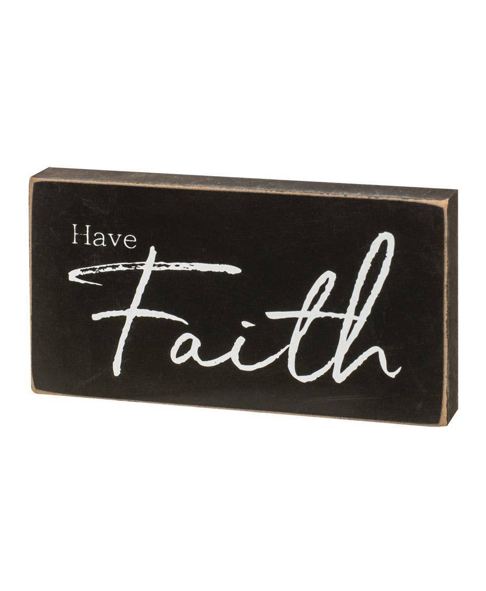 A set of three wooden blocks with motivational phrases printed in white lettering. The phrases are 'Pray more worry less', 'Holy Spirit you are welcome here', and 'Have Faith.