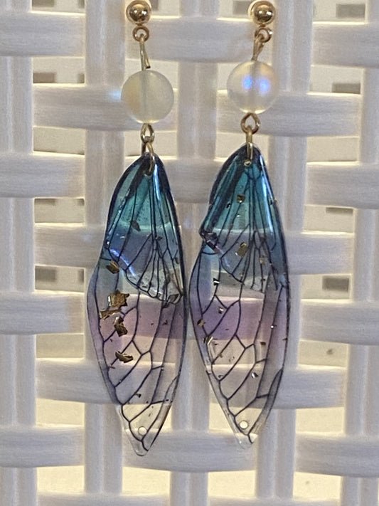 Purple and blue resin butterfly wing earrings with gold-toned post and silicone wire nugs, 2¾ inches long.