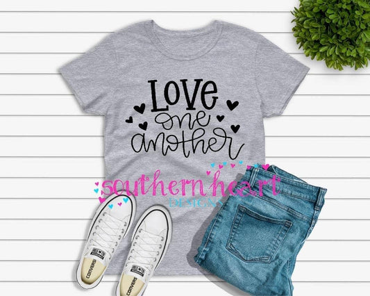 Grey women's t-shirt with black "Love one another" text and black hearts, made of Gildan heavy cotton 50/50 fabric.