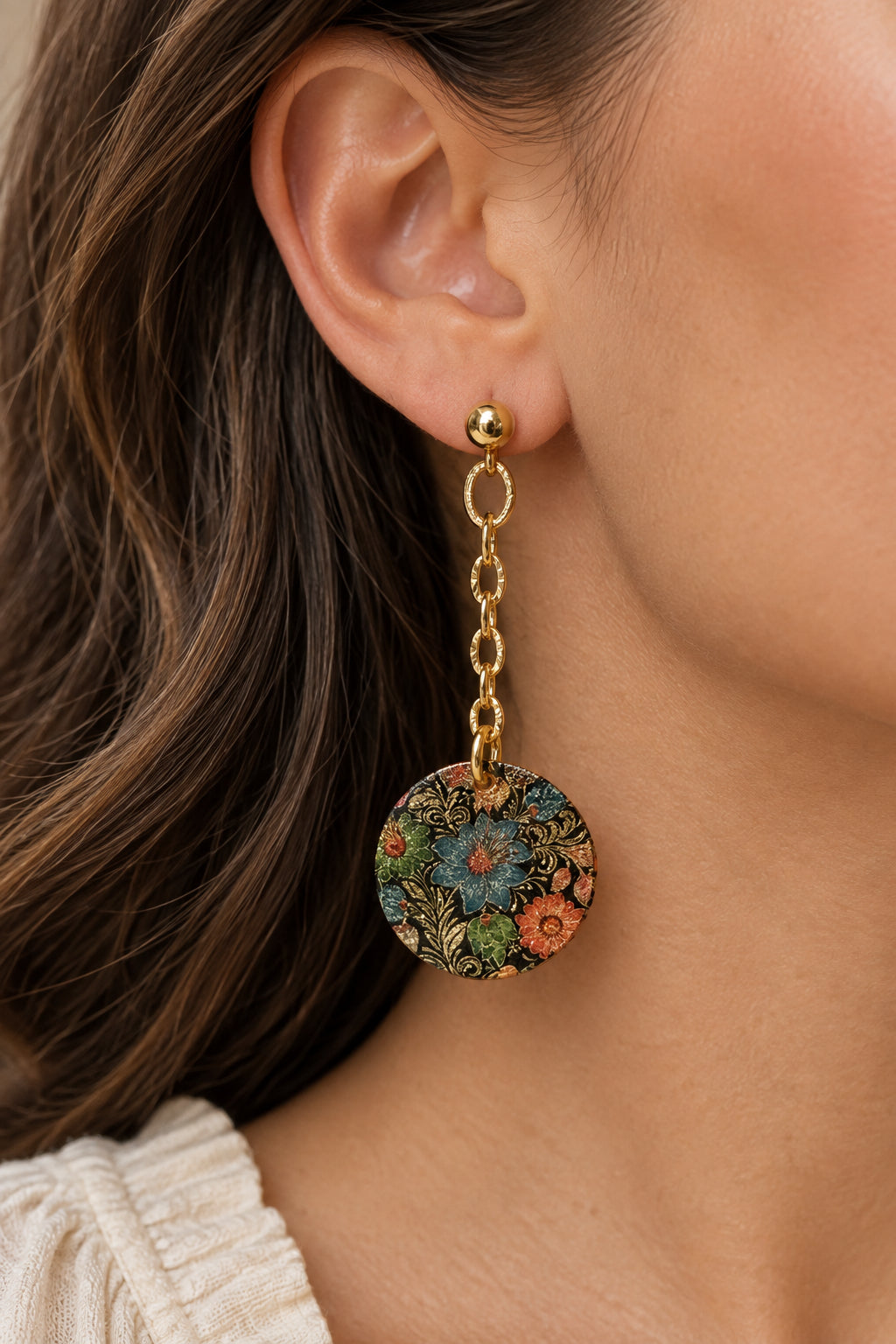 Multicolored floral disc earrings with gold-toned ball posts, silicone stoppers, and decorative chain details.