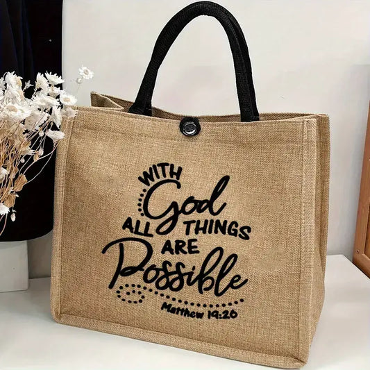 Natural jute tote bag with black cotton handles and button closure, featuring the verse "With God All Things Are Possible – Matthew 19:26" on the front. Measures 12.20" tall x 13.78" wide x 6.69" deep.