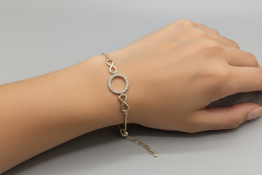 Gold plated adjustable bracelet with rhinestone circle and infinity focal centerpiece, Carletta bracelet elegant jewelry