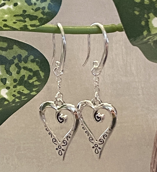 Silver-toned swirly heart earrings in post (1.25") and ear wire (2") styles with silicone nugs.