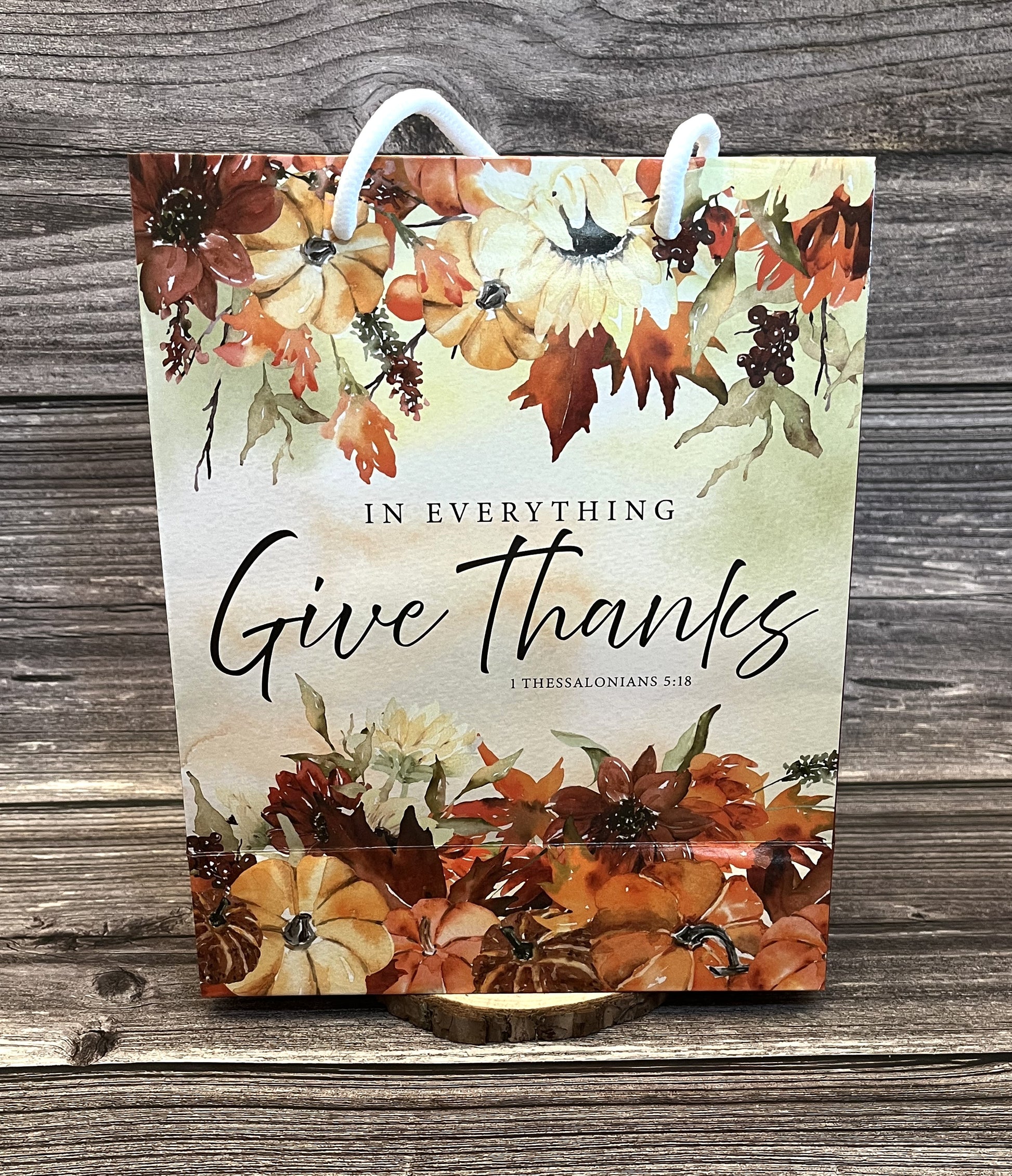 Christian fall paper gift bag with autumn floral design and the Bible verse “In everything give thanks” from 1 Thessalonians 5:18, size 8x10 inches