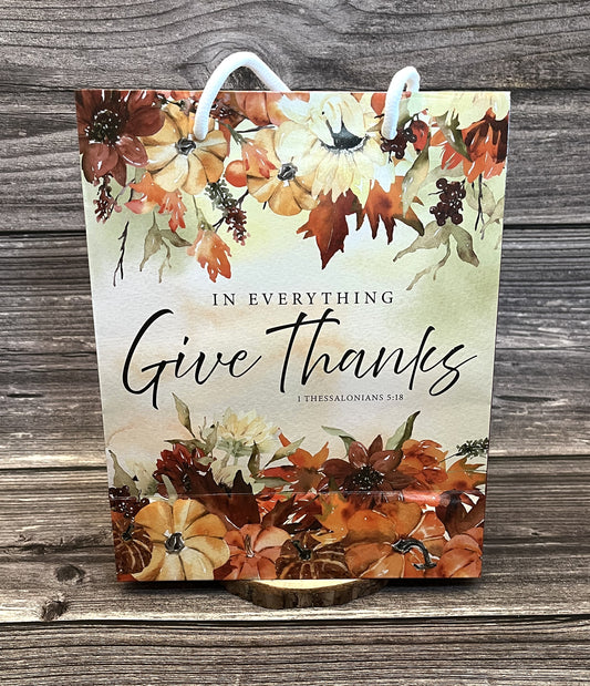 Christian fall paper gift bag with autumn floral design and the Bible verse “In everything give thanks” from 1 Thessalonians 5:18, size 8x10 inches
