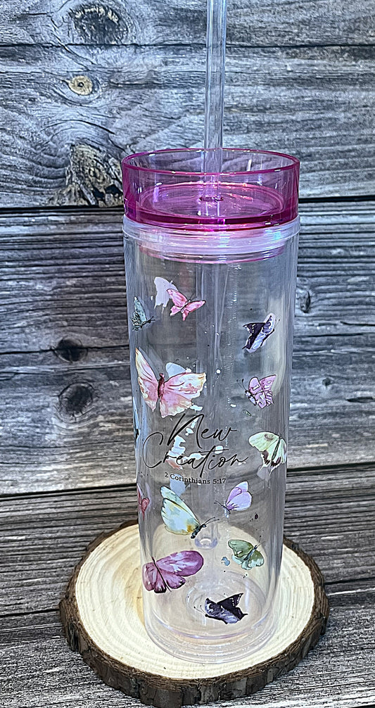 Clear acrylic Christian tumbler with pink lid and straw featuring butterflies and New Creation 2 Corinthians 5:17 KJV Bible verse