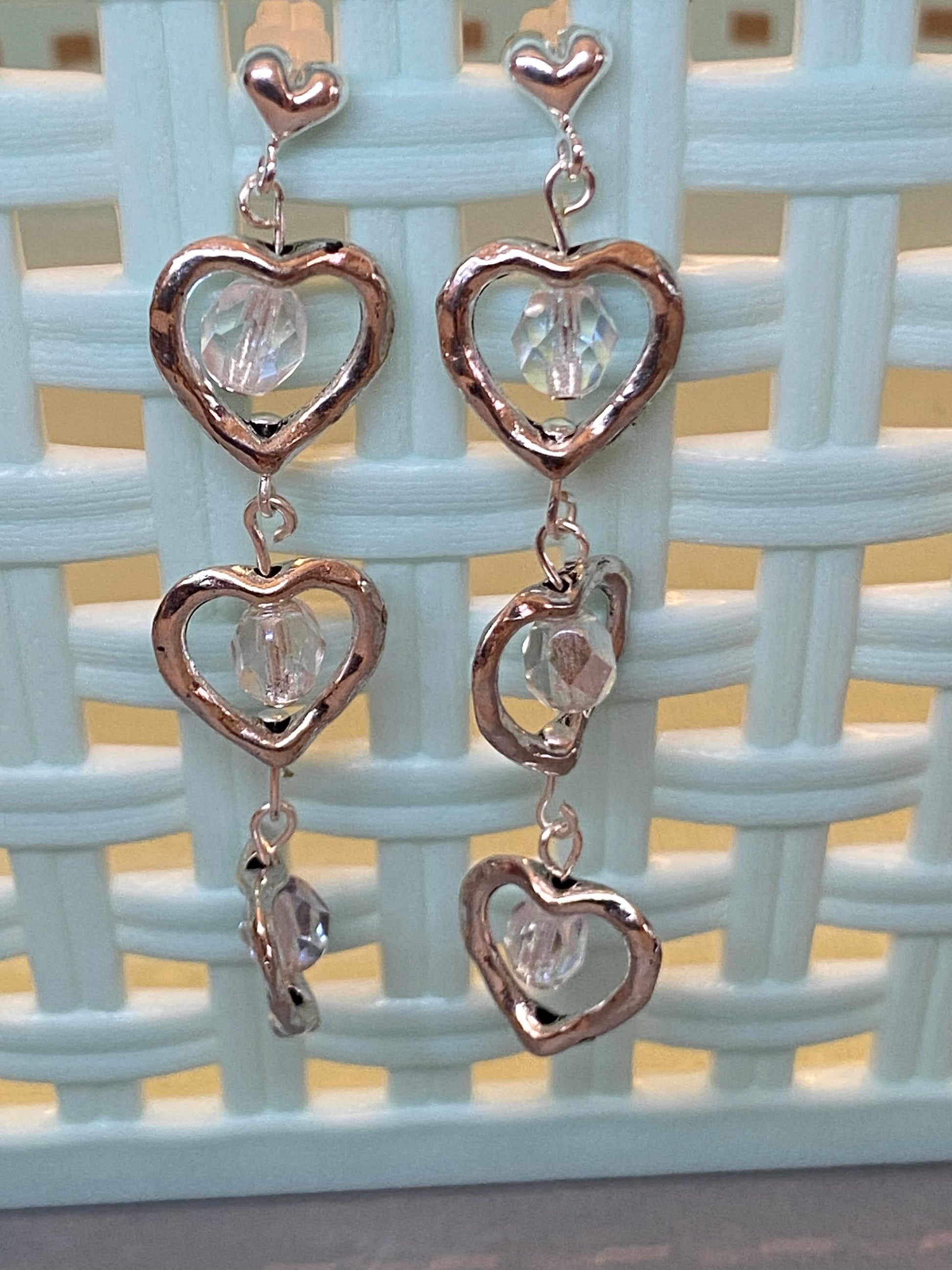 Silver-toned triple heart post earrings with fiery Polish glass beads, approximately 2¼ inches long.
