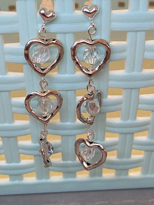 Silver-toned triple heart post earrings with fiery Polish glass beads, approximately 2¼ inches long.